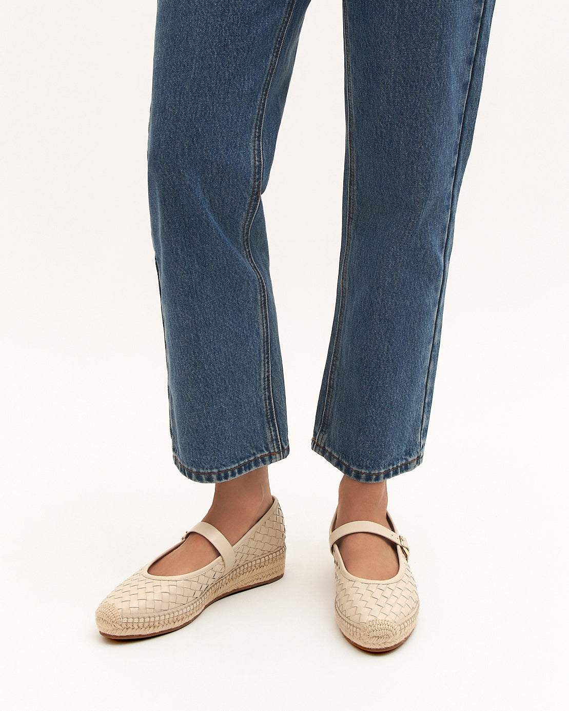 White woven shoe with a strap on a white background