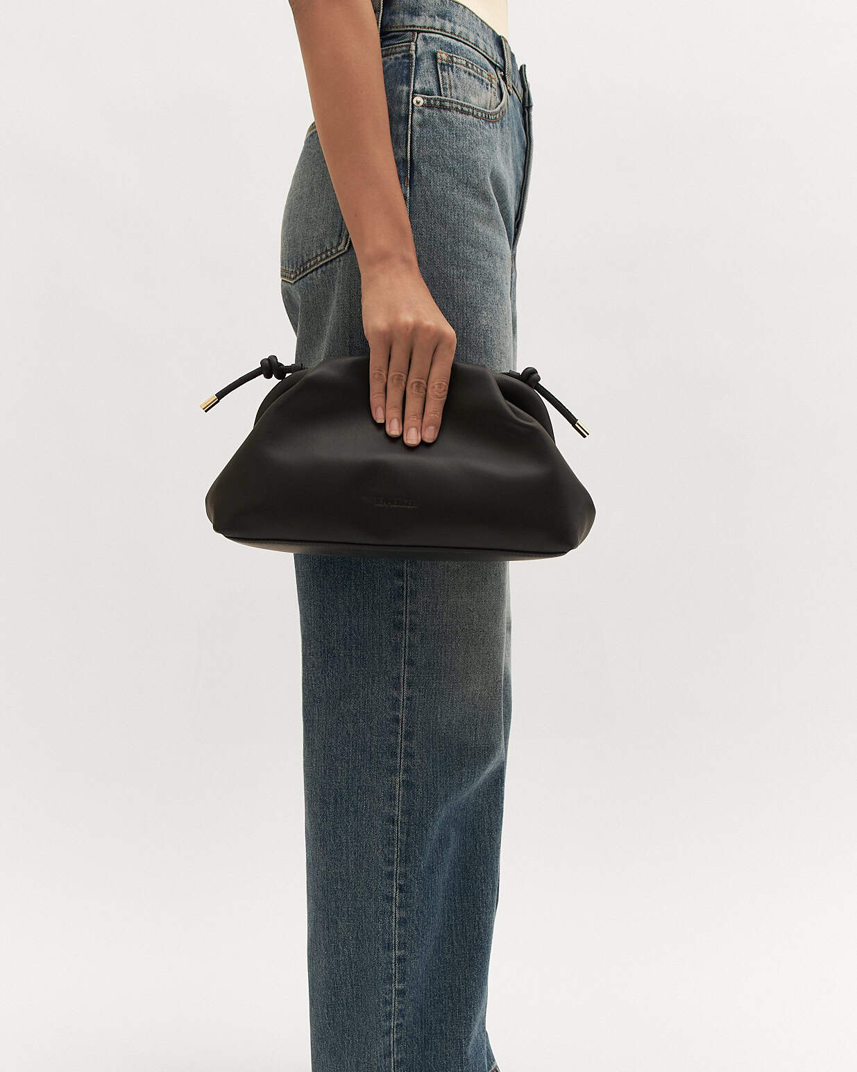Black leather pouch with drawstring on a white background