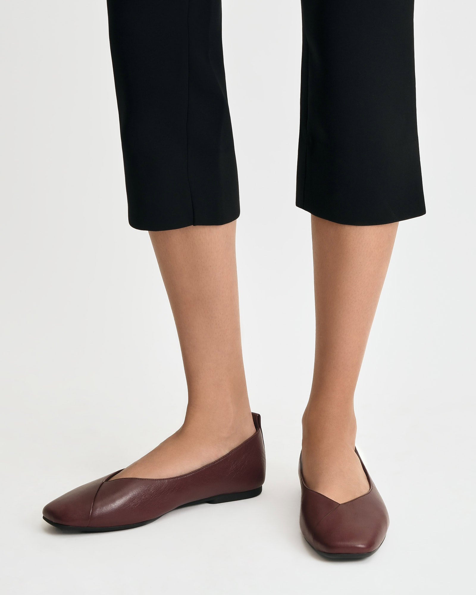 Maroon flat shoe on a white background