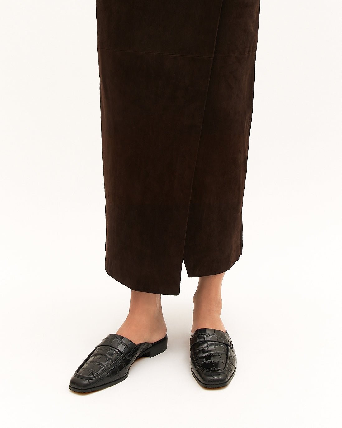 Black crocodile-patterned loafer on a white background