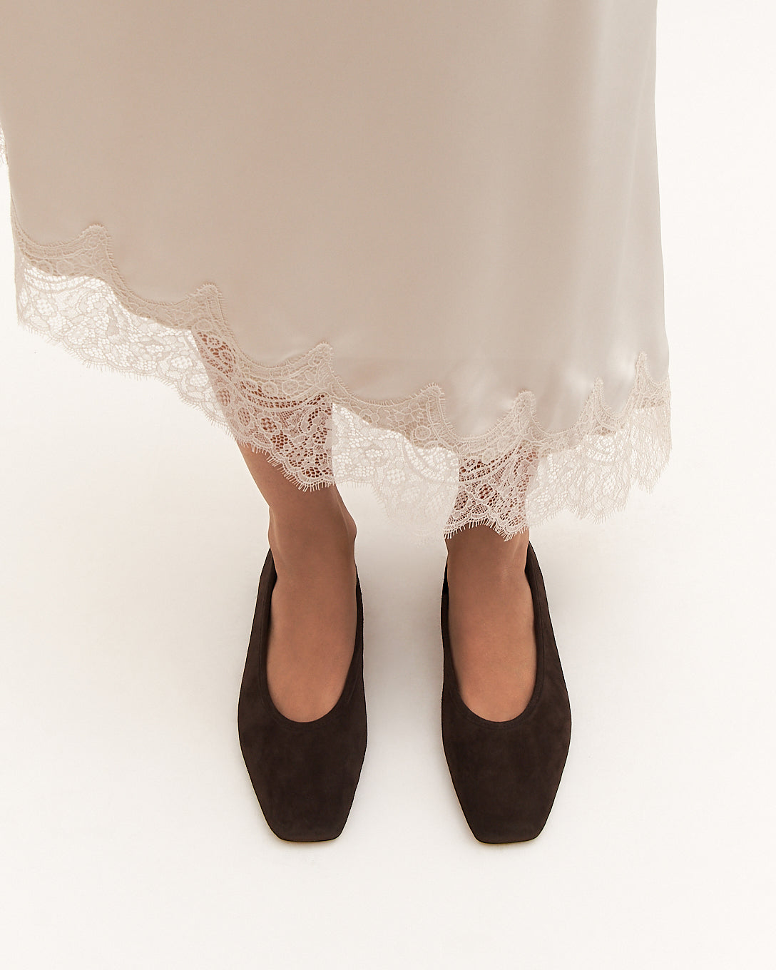 Brown suede flat shoe on a white background