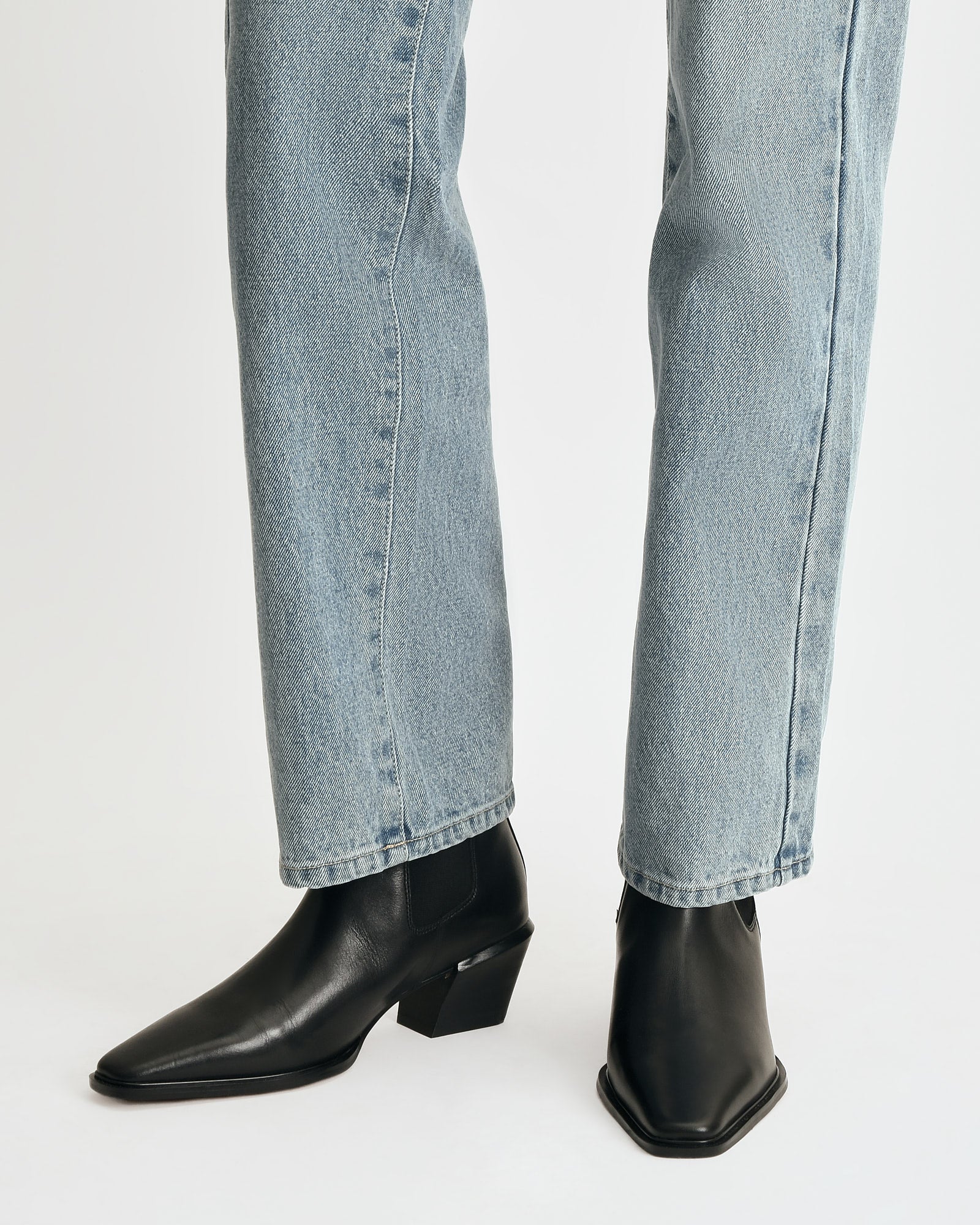 Black ankle boot on a light gray background
