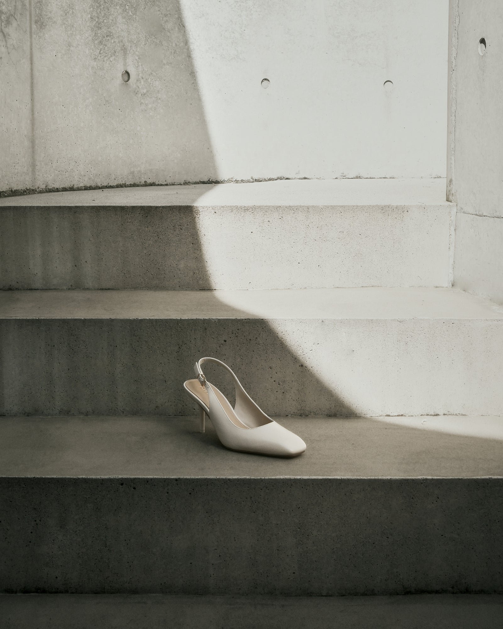 Beige high-heeled shoe on a white background