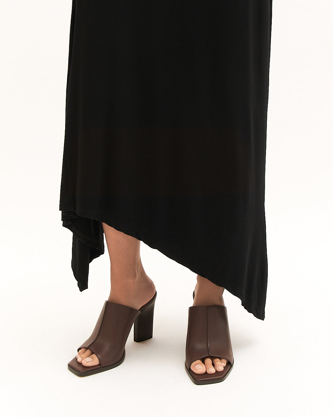 Brown open-toe high-heeled shoe on a light gray background