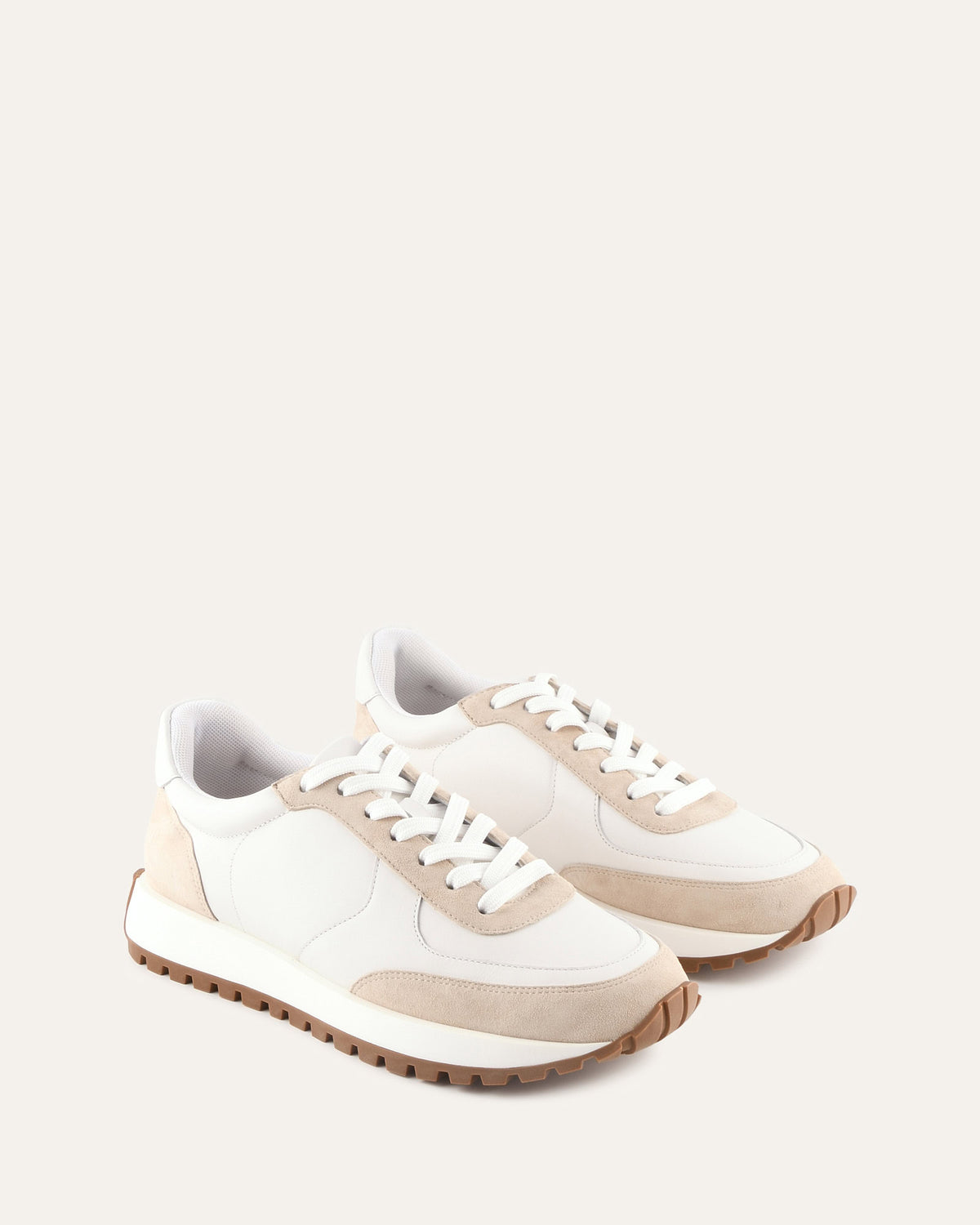 White and beige sneakers on a light gray background