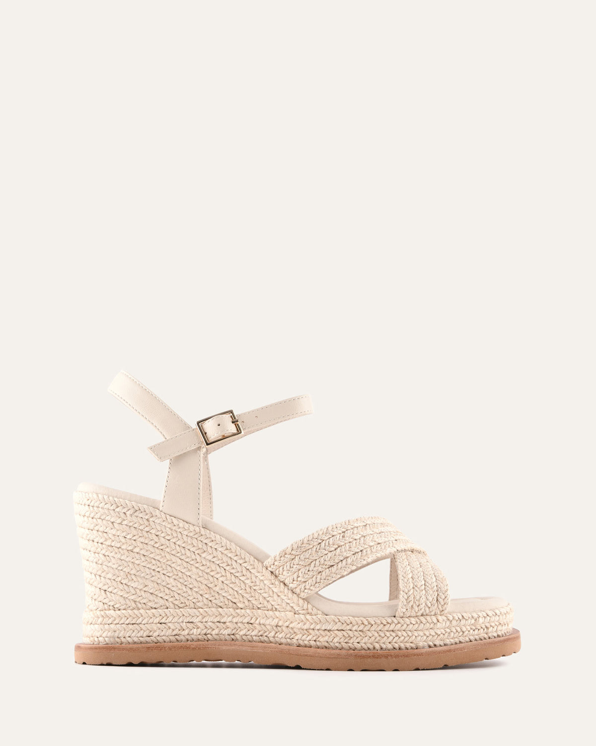 Beige wedge sandal with a strap on a white background