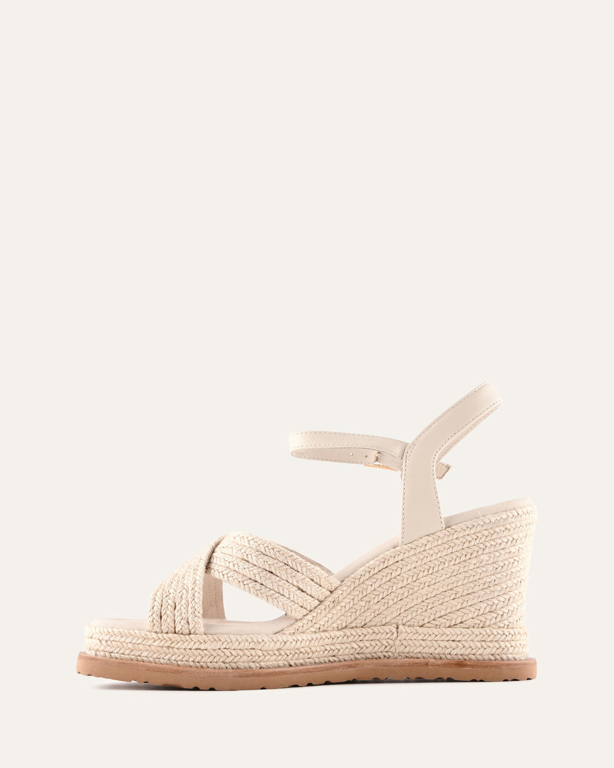 Beige wedge sandal with espadrille sole on a white background