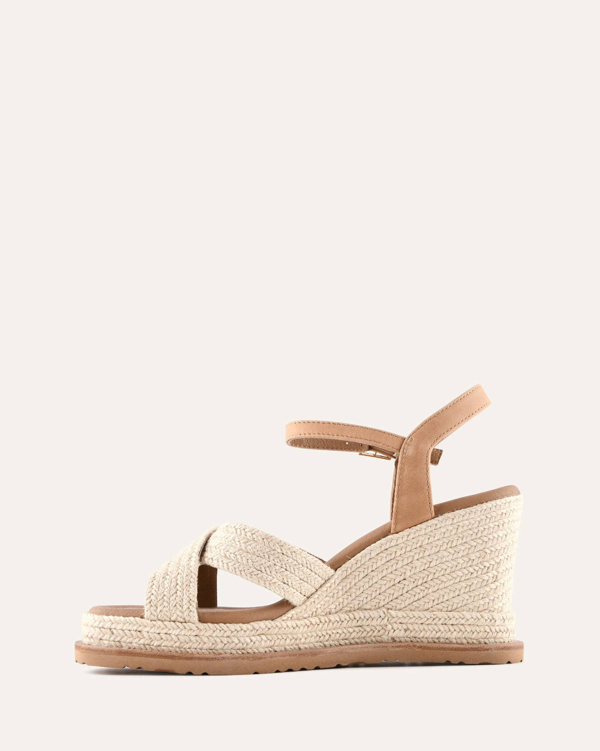 Beige wedge sandal with espadrille sole on a white background