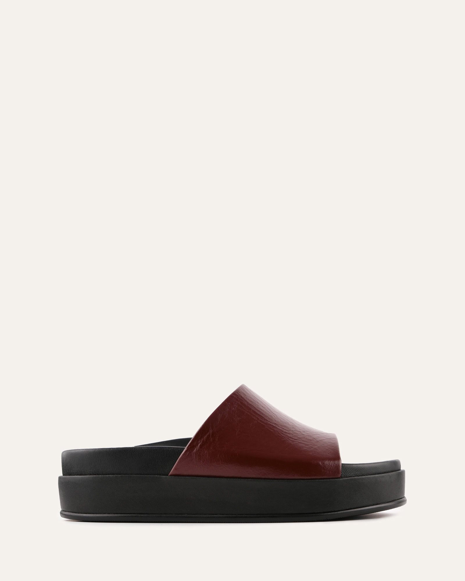 Black and brown slide sandal on a white background