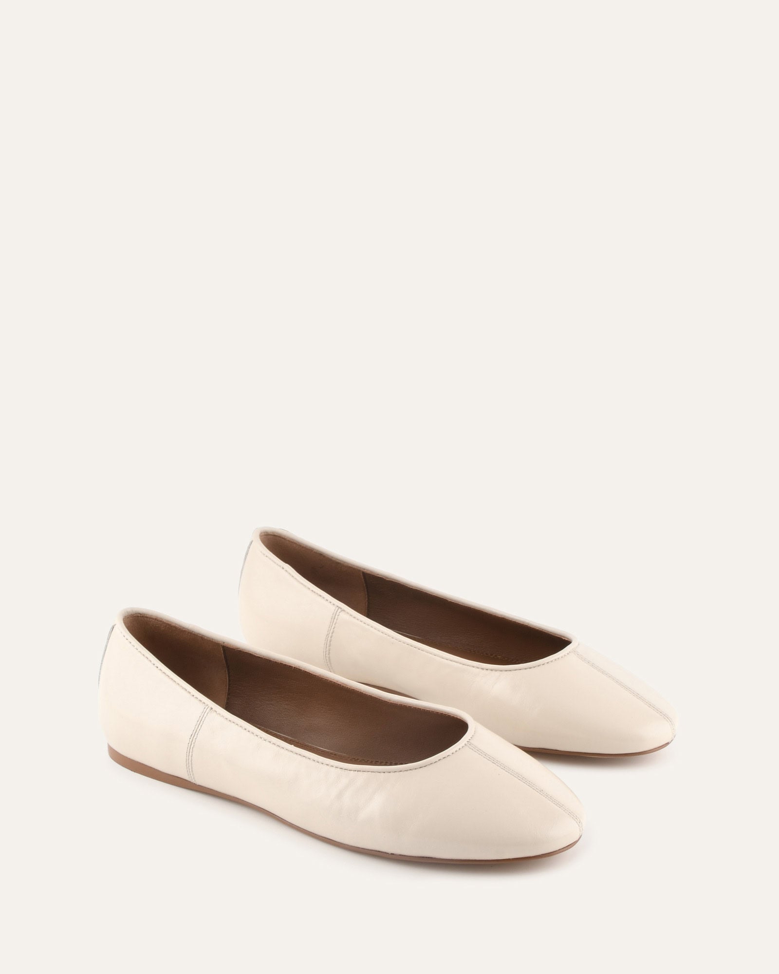 Beige flat shoe on a light beige background