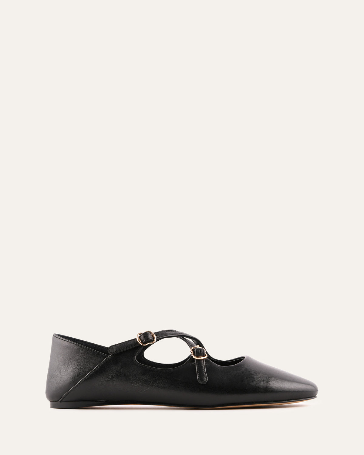 Black flat shoe with a strap on a white background