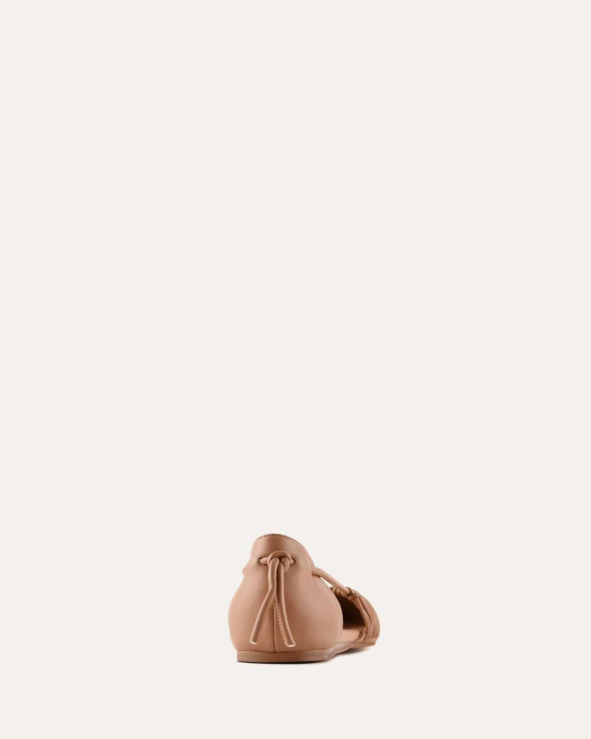 Beige leather bag with drawstring on a light beige background